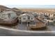 New construction home featuring desert landscaping, paved driveways, modern architecture, and multi-car garages at 522 Riley Ridge Ct, Henderson, NV 89012