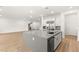 An open concept kitchen with stainless appliances and a large center island with sink at 522 Riley Ridge Ct, Henderson, NV 89012