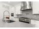 Modern kitchen features stainless appliances, gas range, gray countertop, and mosaic backsplash at 522 Riley Ridge Ct, Henderson, NV 89012
