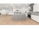 Bright kitchen with white cabinetry, gray countertops, stainless appliances and center island at 522 Riley Ridge Ct, Henderson, NV 89012