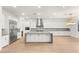 A spacious kitchen with white cabinets, gray countertops, and stainless steel appliances at 522 Riley Ridge Ct, Henderson, NV 89012