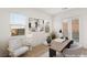 Bright home office featuring a modern desk, stylish seating, and ample natural light for a productive workspace at 522 Riley Ridge Ct, Henderson, NV 89012