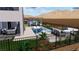 This exterior view shows a pool with a covered outdoor kitchen and desert landscaping, surrounded by a black metal fence at 522 Riley Ridge Ct, Henderson, NV 89012