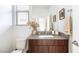 Stylish half bathroom with a modern vanity, decorative accents, and neutral tones at 524 Grand Cascade Pl, North Las Vegas, NV 89084