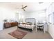 Bright bedroom features a bed, dresser, and a dedicated desk space under natural light at 524 Grand Cascade Pl, North Las Vegas, NV 89084