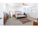 Spacious bedroom features a bed, dresser, mirror, and ample natural light from several windows at 524 Grand Cascade Pl, North Las Vegas, NV 89084