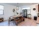 Dining area with a wooden table, bench seating, and modern light fixture at 524 Grand Cascade Pl, North Las Vegas, NV 89084