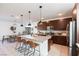 Modern kitchen featuring a spacious island, stainless steel appliances, and dark wood cabinetry at 524 Grand Cascade Pl, North Las Vegas, NV 89084