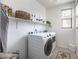 Functional laundry room featuring modern appliances, storage shelves, and ample lighting at 524 Grand Cascade Pl, North Las Vegas, NV 89084