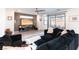Comfortable living room with a large sectional sofa and sliding glass doors to the patio at 524 Grand Cascade Pl, North Las Vegas, NV 89084