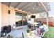 Entertainer's backyard patio, complete with dining table, comfortable seating, tv, and string lights at 524 Grand Cascade Pl, North Las Vegas, NV 89084