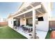 Relaxing covered patio featuring a built-in pergola, modern furniture, and outdoor television at 524 Grand Cascade Pl, North Las Vegas, NV 89084