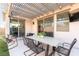 Cozy outdoor patio with comfortable seating, dining table, and outdoor television for entertaining at 524 Grand Cascade Pl, North Las Vegas, NV 89084