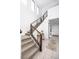 Modern staircase with wooden railings, and lots of natural light from high windows at 524 Grand Cascade Pl, North Las Vegas, NV 89084