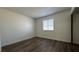 Bright bedroom features wood-look floors, a window with blinds, and fresh white paint throughout at 567 Roxella Ln # D, Las Vegas, NV 89110