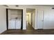Bright bedroom with a laundry closet, fresh white paint and wood-look floors at 567 Roxella Ln # D, Las Vegas, NV 89110