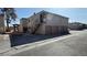 Tan apartment building with brown garages and stairwells on sunny day at 567 Roxella Ln # D, Las Vegas, NV 89110