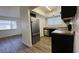 Modern kitchen features stainless steel appliances, dark cabinets, and wood-look flooring at 567 Roxella Ln # D, Las Vegas, NV 89110