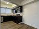 Kitchen featuring black appliances and cabinets with light countertops and backsplash at 567 Roxella Ln # D, Las Vegas, NV 89110