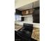 This well-appointed kitchen features granite countertops, stainless steel appliances, and dark cabinetry at 567 Roxella Ln # D, Las Vegas, NV 89110