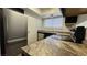 A kitchen boasts stainless steel appliances, a granite countertop, and neutral backsplash at 567 Roxella Ln # D, Las Vegas, NV 89110