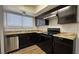 Updated kitchen showcases sleek black cabinetry, granite countertops, and stainless steel appliances at 567 Roxella Ln # D, Las Vegas, NV 89110
