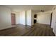Open living space with hardwood floors leading to the entry door and kitchen at 567 Roxella Ln # D, Las Vegas, NV 89110