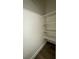 Walk-in storage area features wood-look flooring and white shelving at 567 Roxella Ln # D, Las Vegas, NV 89110