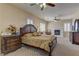 Luxurious main bedroom with a fireplace, plantation shutters, and elegant furnishings, offering a serene space at 6377 Elizabethtown Ave, Las Vegas, NV 89110