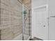 Tiled walk-in shower featuring glass door and white door in the bathroom at 6434 Spring Jog St, Las Vegas, NV 89166