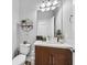 Half bathroom featuring wood-look floors, toilet, cabinet, and unique decorations at 6434 Spring Jog St, Las Vegas, NV 89166