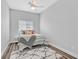 Cozy bedroom featuring a metal frame bed, overhead fan, and a modern patterned rug at 6434 Spring Jog St, Las Vegas, NV 89166