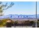Distant city view from community, with mountain backdrop and neighborhood rooftops in the foreground at 6434 Spring Jog St, Las Vegas, NV 89166