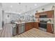 Open concept kitchen with a breakfast bar, stainless steel dishwasher, and connection to the living area at 6434 Spring Jog St, Las Vegas, NV 89166