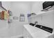 Laundry room featuring modern washer and dryer with shelving, decor, and storage at 6434 Spring Jog St, Las Vegas, NV 89166