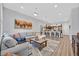 Inviting living room with a cozy couch, and an open floor plan to the kitchen at 6434 Spring Jog St, Las Vegas, NV 89166