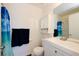 Bright bathroom featuring modern fixtures, a vanity cabinet, and a framed mirror at 645 Utah St, Boulder City, NV 89005