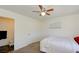 Simple carpeted bedroom with a ceiling fan and access to an ensuite bathroom at 645 Utah St, Boulder City, NV 89005