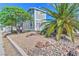 View of the home exterior featuring a desert landscaped yard with mature trees at 645 Utah St, Boulder City, NV 89005