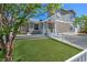 Charming home showcasing a well-maintained yard with lush lawn and welcoming entrance at 645 Utah St, Boulder City, NV 89005