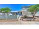 Inviting home exterior with a well-kept lawn, mature trees, and cozy entrance at 645 Utah St, Boulder City, NV 89005