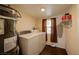 Functional laundry room with a washer, dryer, and water heater at 645 Utah St, Boulder City, NV 89005