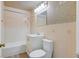 Cozy bathroom featuring a tub-shower combo, decorative tiles, and neutral fixtures at 657 Burton St, Henderson, NV 89015