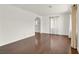 Spacious room with hardwood floors, two large windows, and white walls; neutral and bright at 657 Burton St, Henderson, NV 89015