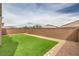 This fenced backyard features artificial turf and gravel at 6904 Baylor Creek St, North Las Vegas, NV 89086