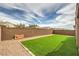 The backyard has artificial turf and a brick privacy fence at 6904 Baylor Creek St, North Las Vegas, NV 89086