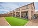 An exterior view of the house showcasing a spacious backyard with patio and balcony at 6904 Baylor Creek St, North Las Vegas, NV 89086