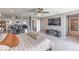 Carpeted bedroom with gray walls, ceiling fan, workspace and a television mounted to the wall at 6904 Baylor Creek St, North Las Vegas, NV 89086