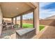 Relax on this covered patio that features brick pavers and opens to the backyard at 6904 Baylor Creek St, North Las Vegas, NV 89086