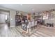 Dining area featuring a dark wood table, seating for six, and decorative bookshelves at 6904 Baylor Creek St, North Las Vegas, NV 89086